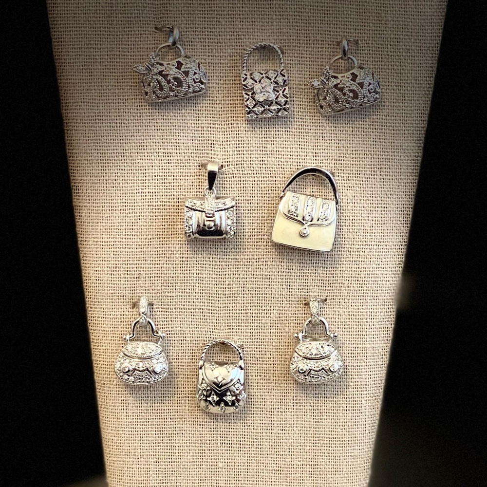 Set of 8 Silver-toned handbag charms.